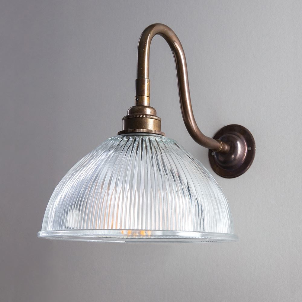 An Old School Electric Prismatic Dome Swan Arm Wall Light with a glass shade.