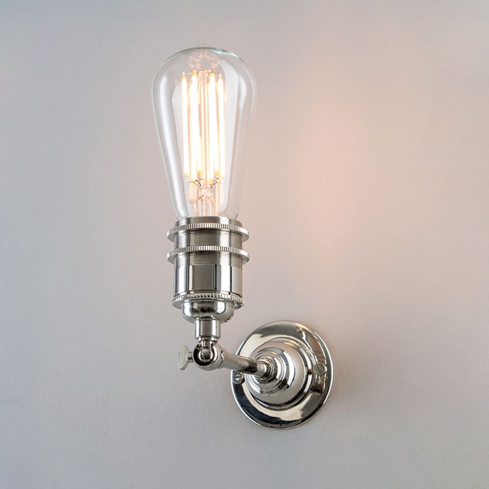 An Industrial Wall Light by Old School Electric, with a light bulb on it, serving as a light fitting.