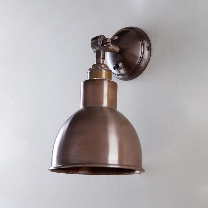 A designer Old School Electric Churchill Short Arm Wall Light fitting on a white wall.