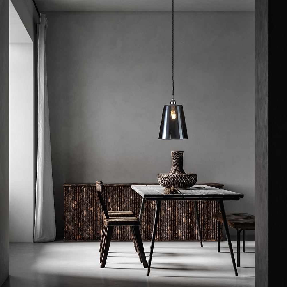 A modern dining room with a table and chairs illuminated by Old School Electric's Tapered Blown Smoked Glass Pendant Light.