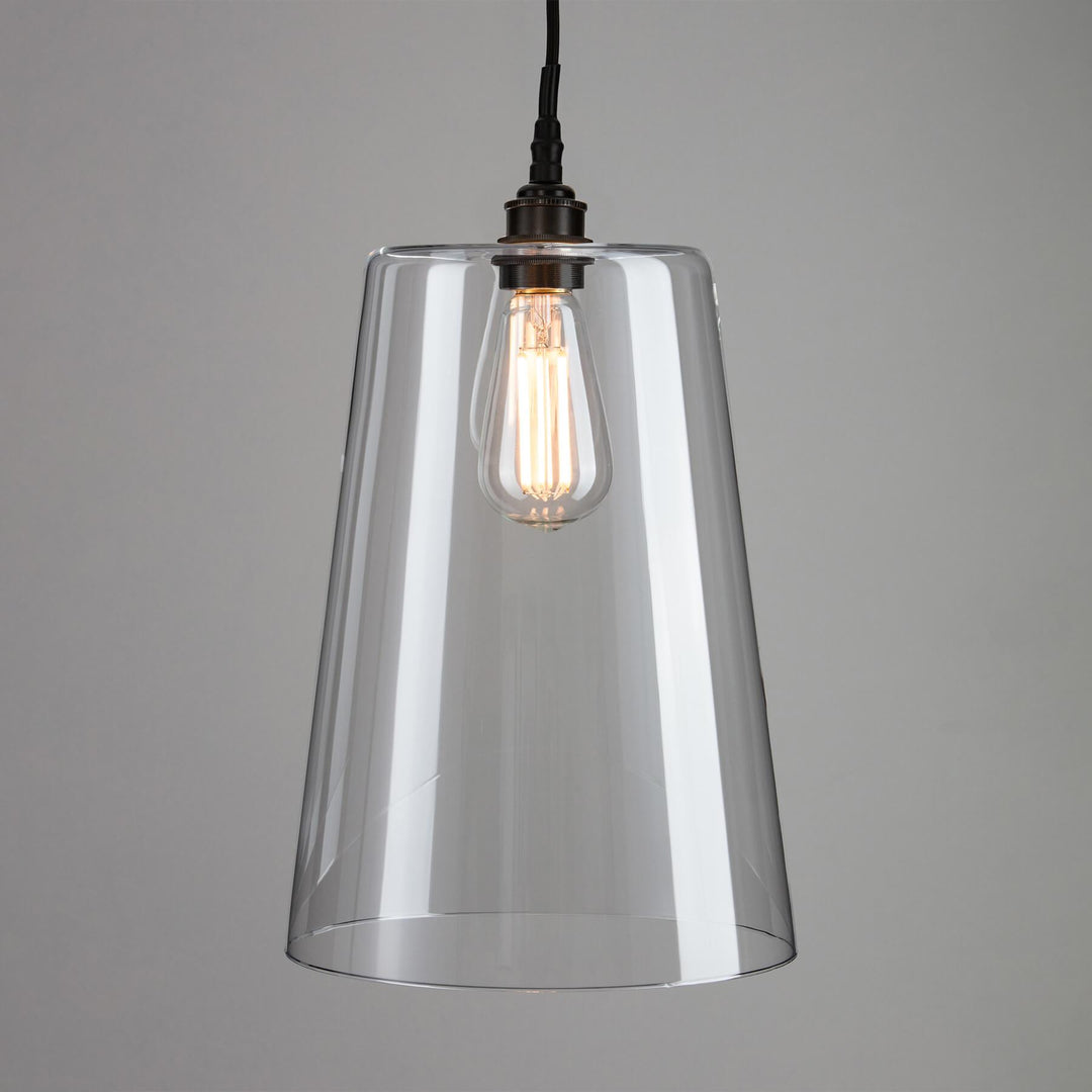 An Old School Electric Tapered Blown Glass Bathroom Pendant Light fixture with a light bulb.