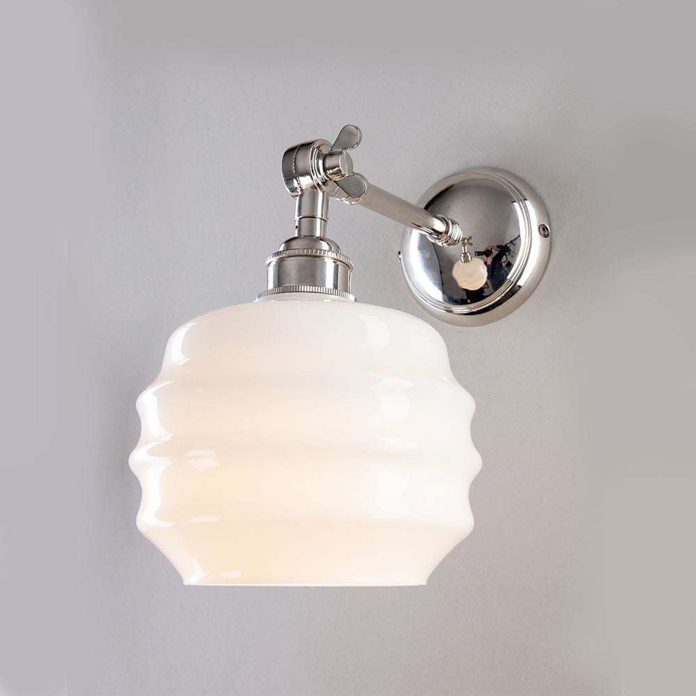 This Deco Opal Adjustable Arm Wall Light by Old School Electric features a frosted glass shade, providing elegant and stylish lighting for any space.