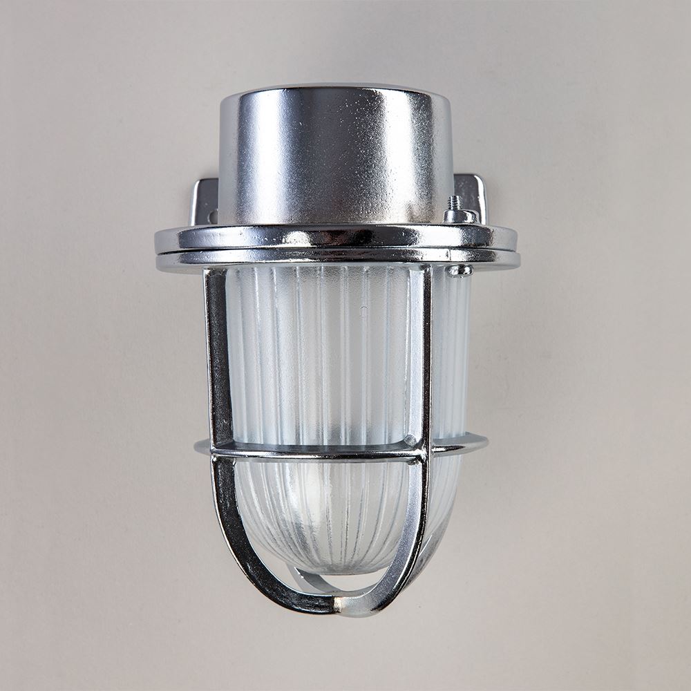 An electric Faros Mini Yacht Wall Light fixture with a glass shade on a white wall by Old School Electric.
