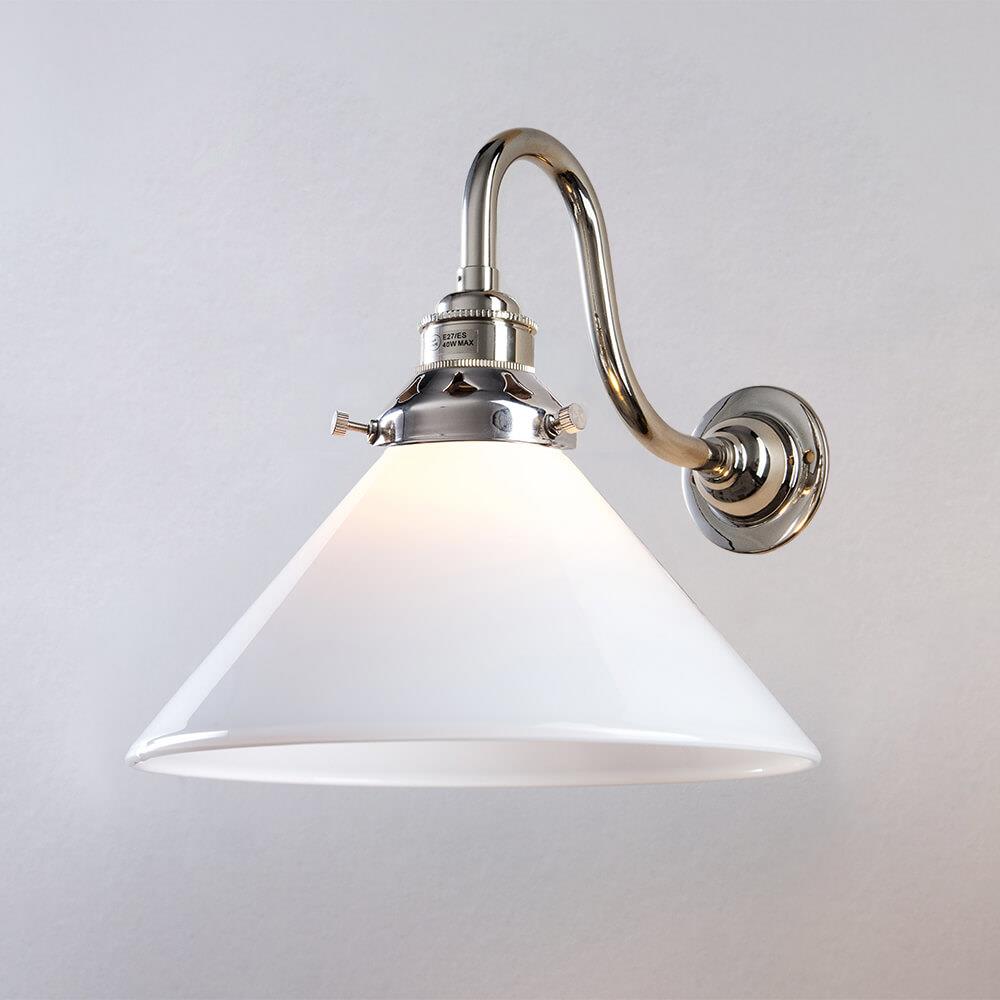 An Old School Electric Conical Bathroom Glass Wall Light with a white shade on a white wall.