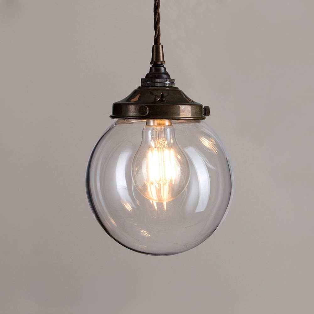 An Old School Electric brass chain hangs a Globe Blown Glass Pendant Light (B22), creating an elegant lighting fixture.