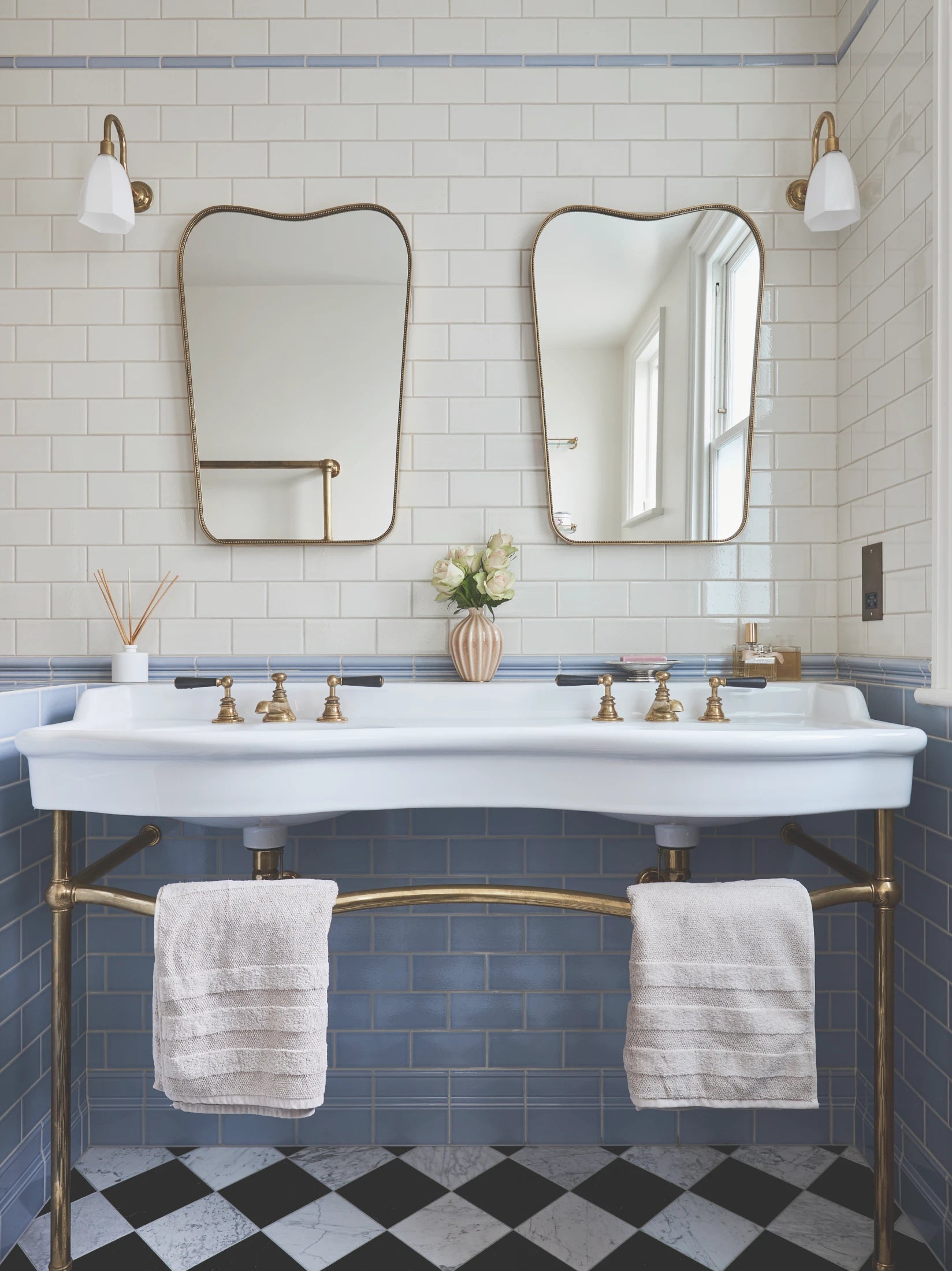 A bathroom with a sink and mirrors.