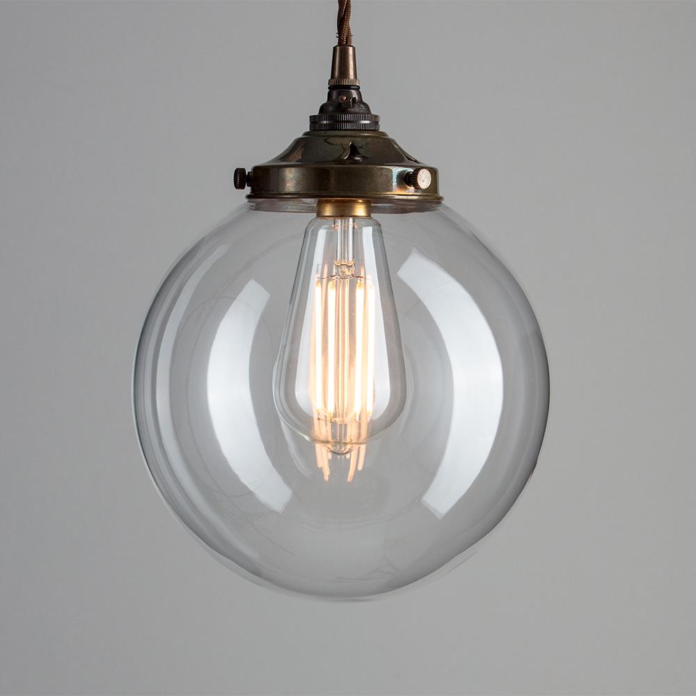 An Old School Electric Globe Blown Glass Pendant Light fixture with a clear glass globe and a brass chain.