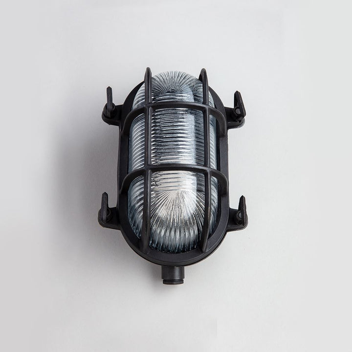 An Oval Bulkhead light fixture from Old School Electric, in black and silver.