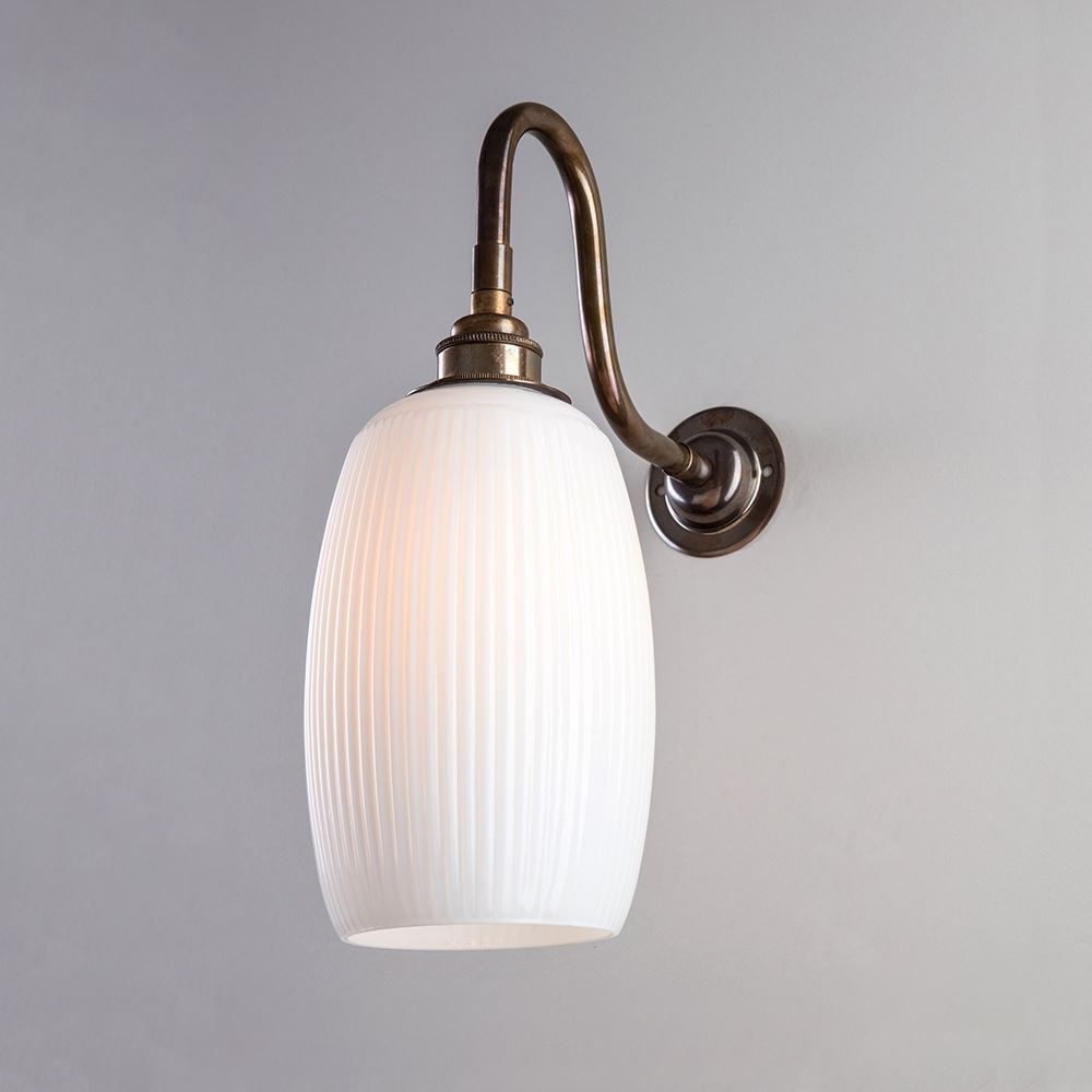A Gillespie Wall Light from Old School Electric, with a white glass shade.