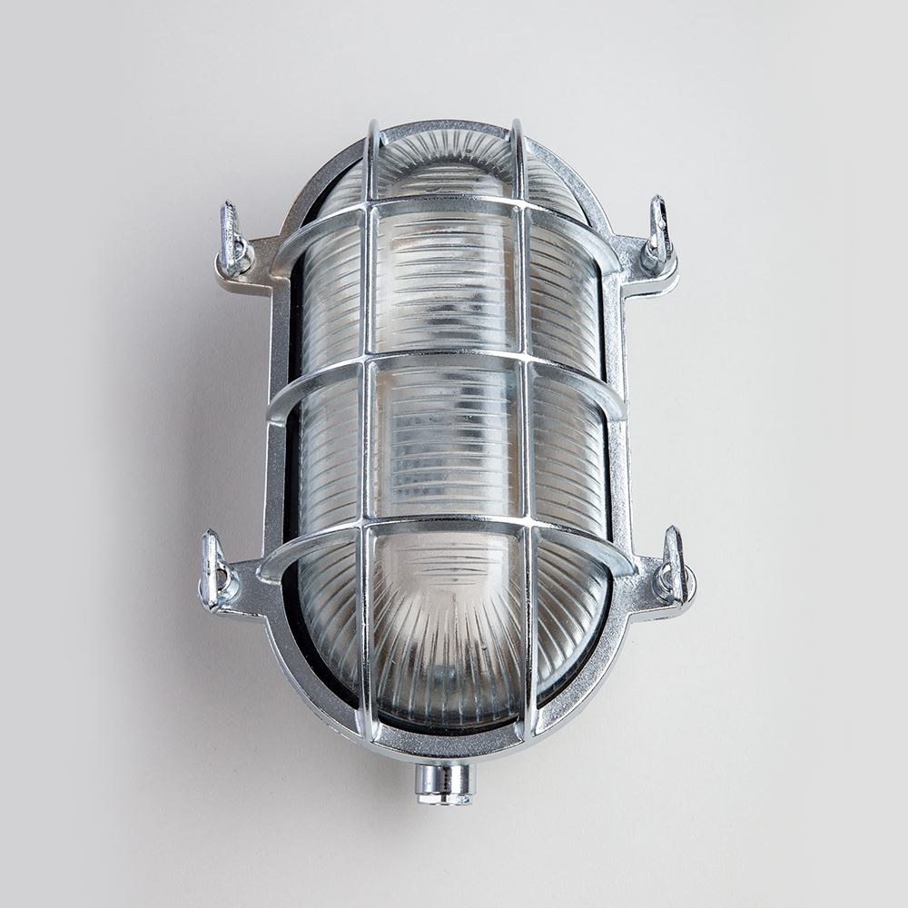 An Old School Electric Oval Bulkhead lighting fixture for outdoor wall with a white background.