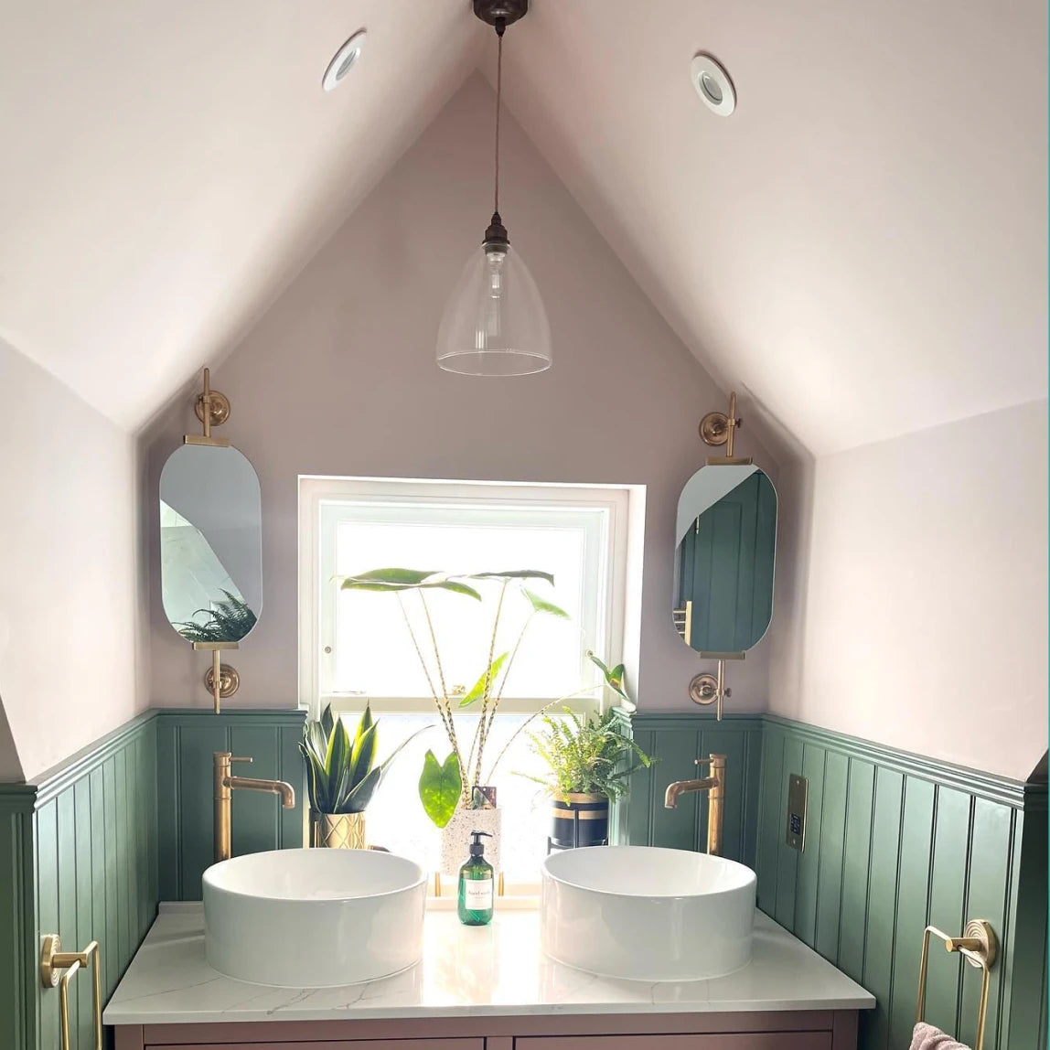 A bathroom with two sinks and a window.