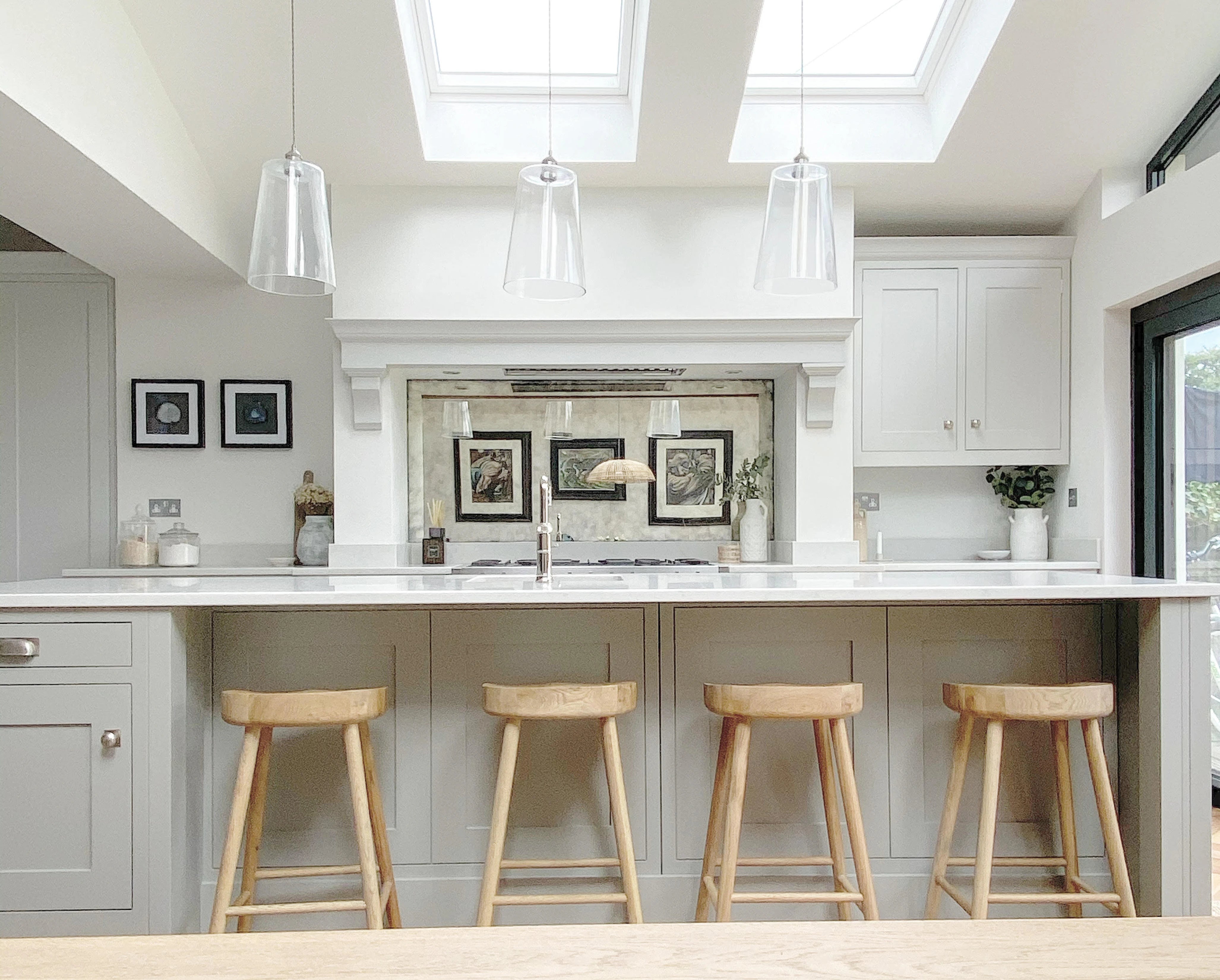 A kitchen with a bar and stools.