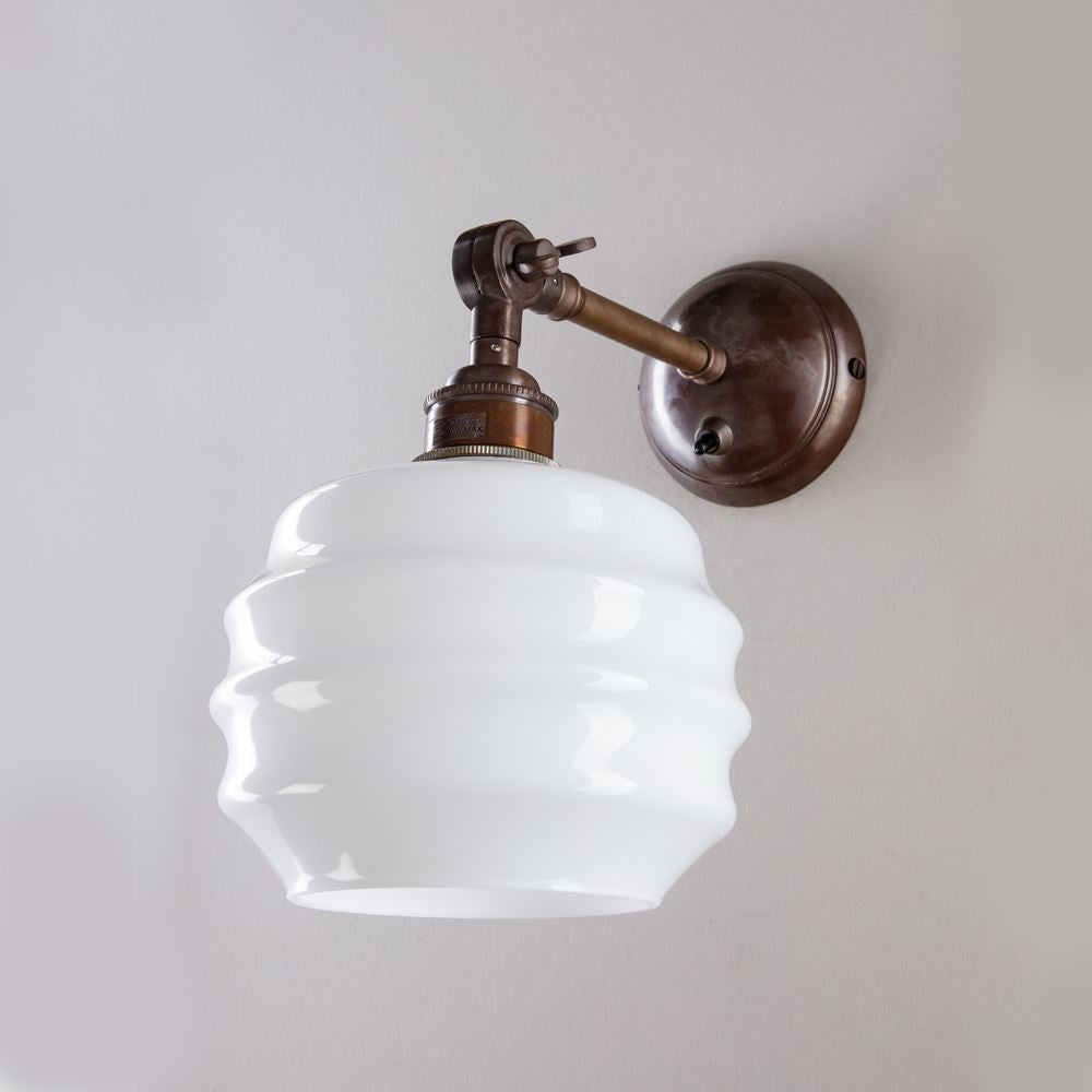 An Old School Electric Deco Opal Adjustable Arm Wall Light with a white glass shade that provides soft and stylish lighting.
