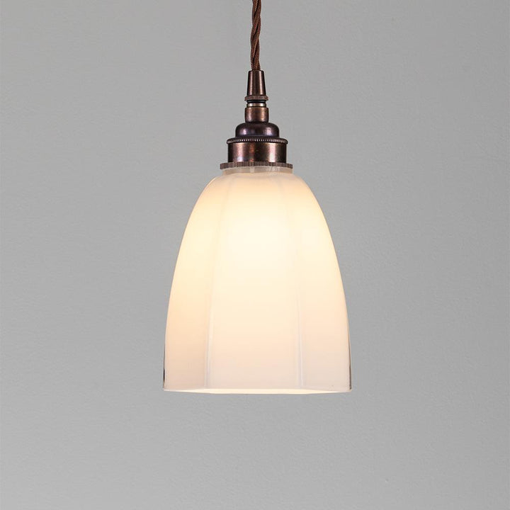 An Old School Electric Hexagon Pendant Light with a white glass shade that provides electric lighting.