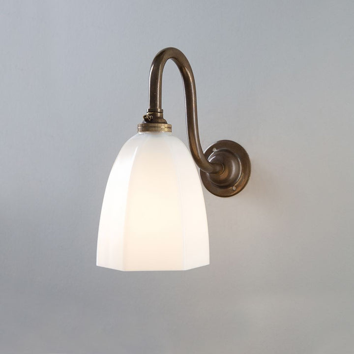 An Old School Electric Hexagon Swan Wall Light fixture with a white glass shade.