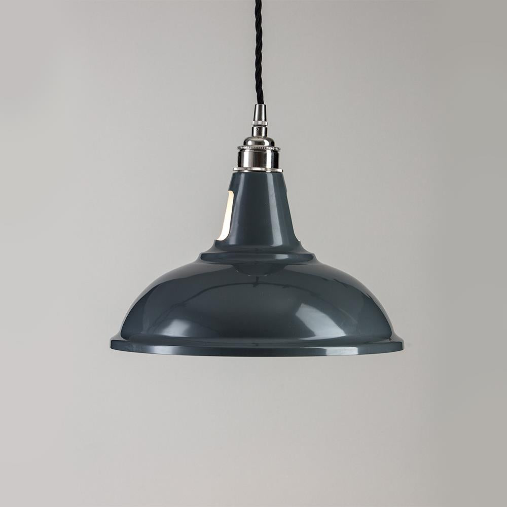 An Old School Electric Factory Pendant Light hanging on a white wall.