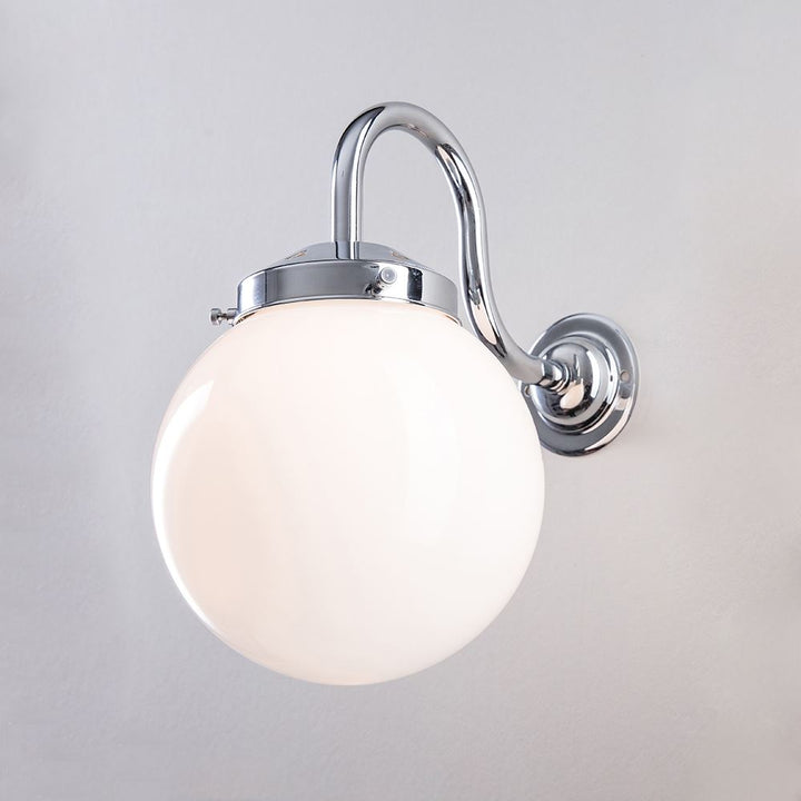 An Opal Globe Wall Light with a white globe on it. This Old School Electric fixture provides stunning illumination as an electric light.