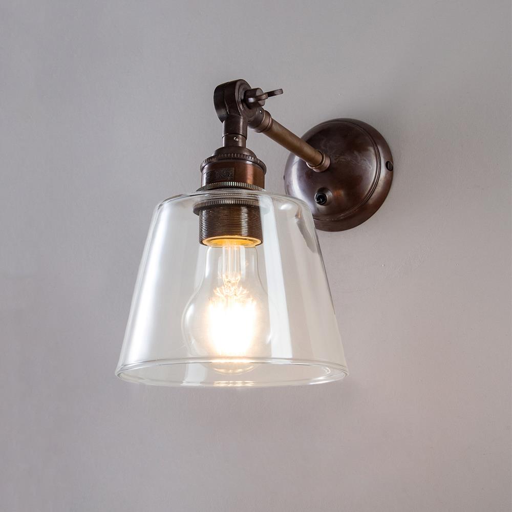 An Old School Electric Glass Adjustable Arm Wall Light with a glass shade.