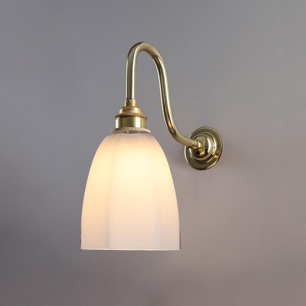 An Old School Electric Hexagon Bathroom Swan Wall Light with a white glass shade.