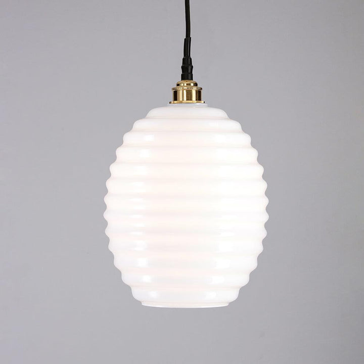 An Beehive Bathroom Pendant Light with a white light and black cord from Old School Electric.