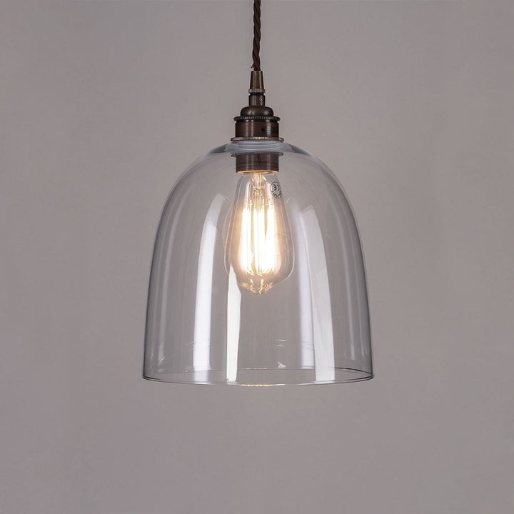 An Old School Electric Bell Blown Glass Pendant Light with a metal chain that provides elegant lighting.