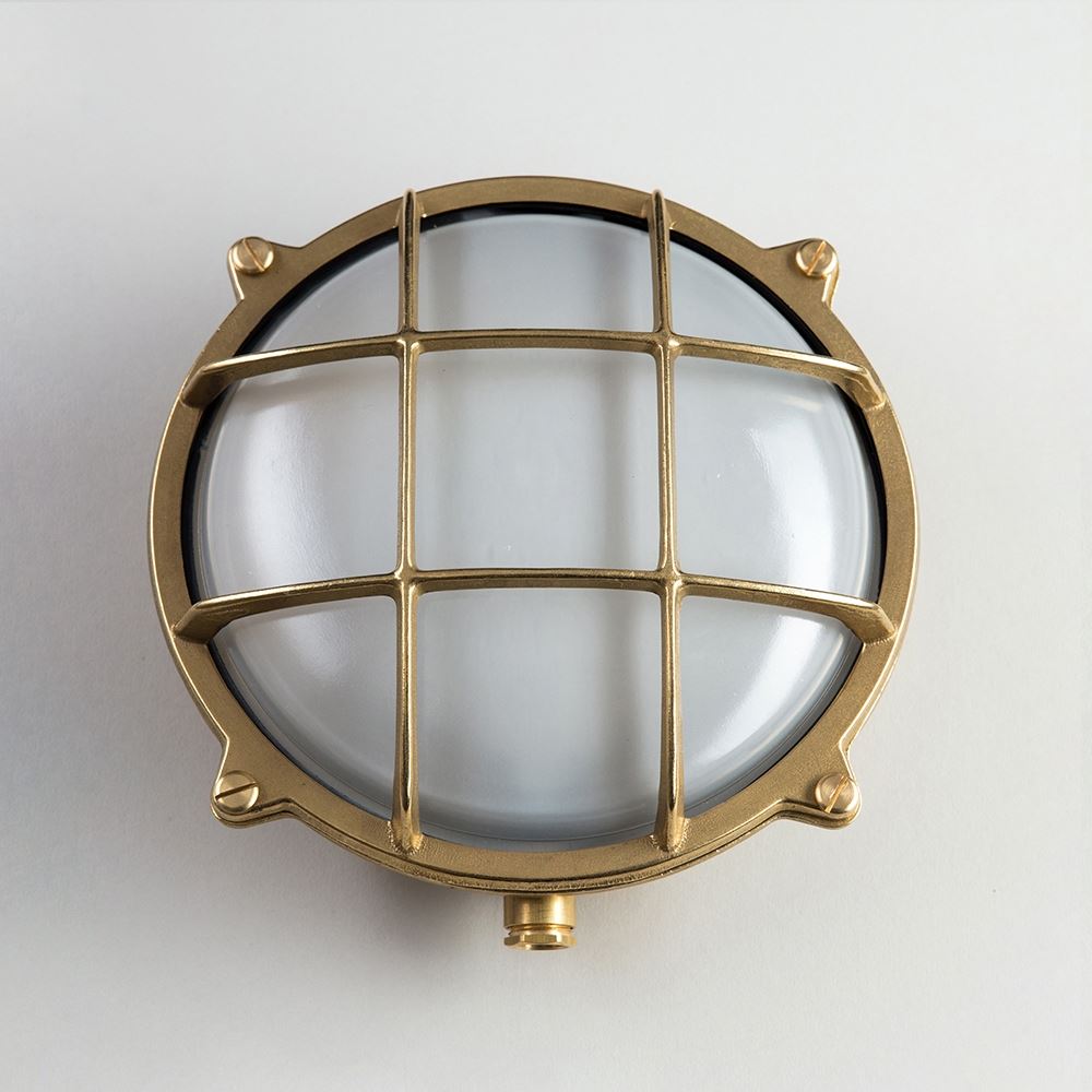 An Old School Electric Round Bulkhead Light fixture with a white glass dome.