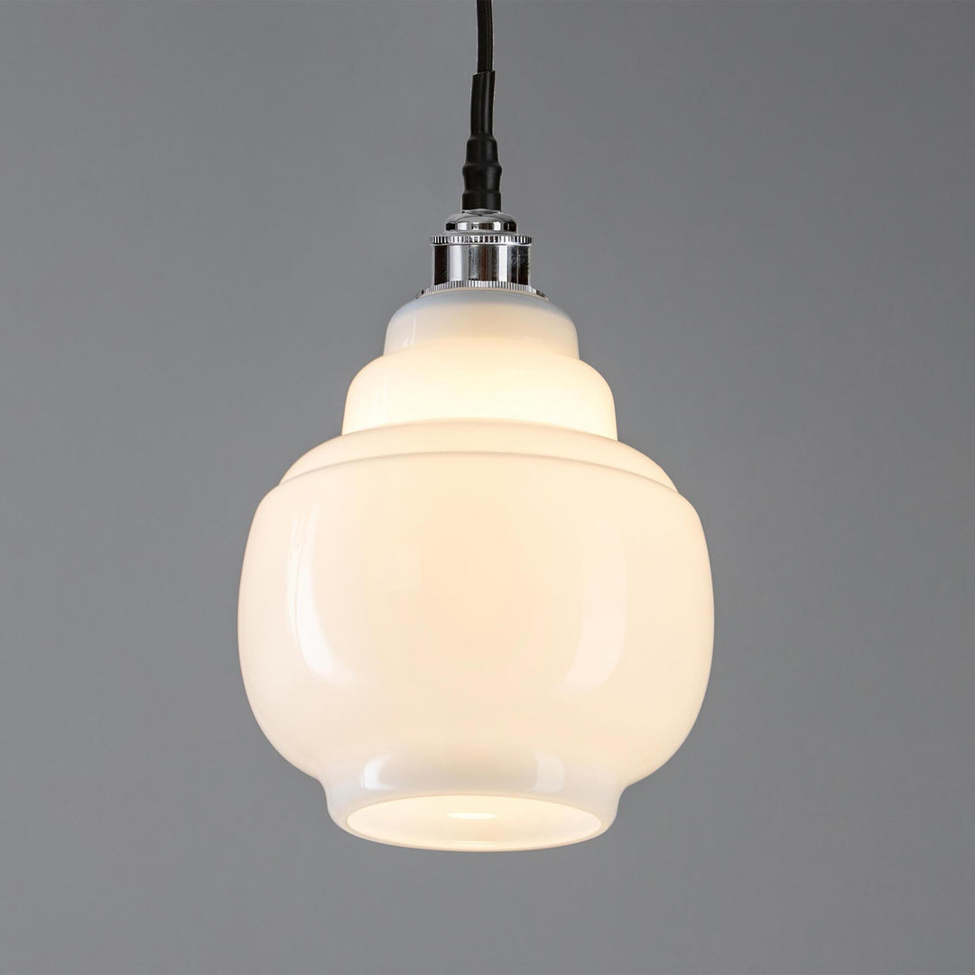 An Old School Electric Barrel Opal Glass Bathroom Pendant Light, a lighting fixture, hanging on a gray background.