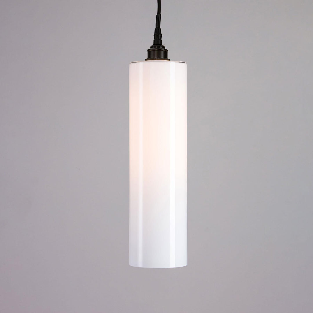An Old School Electric Parker Bathroom Pendant Light, classified as a lighting fixture, hanging on a gray wall.