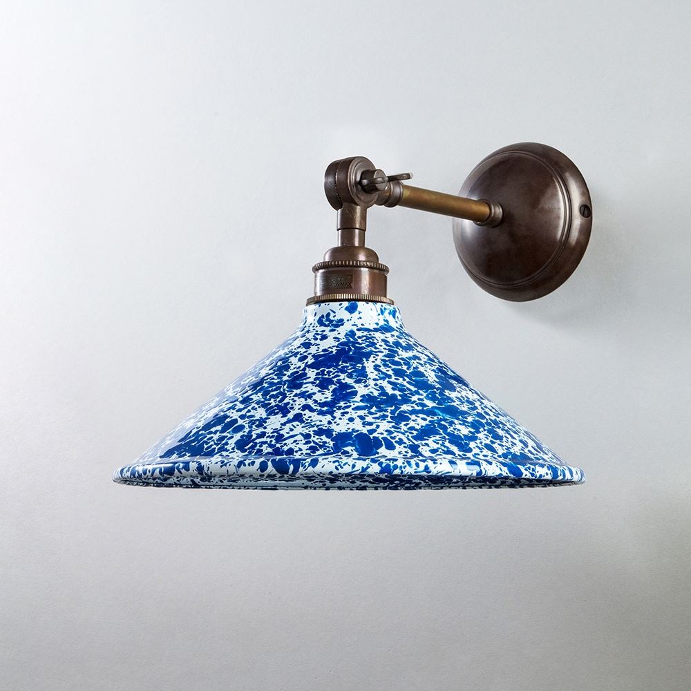 An Old School Electric Splatter Wear Shade Adjustable Arm Wall Light on a white wall, providing elegant lighting fixtures.