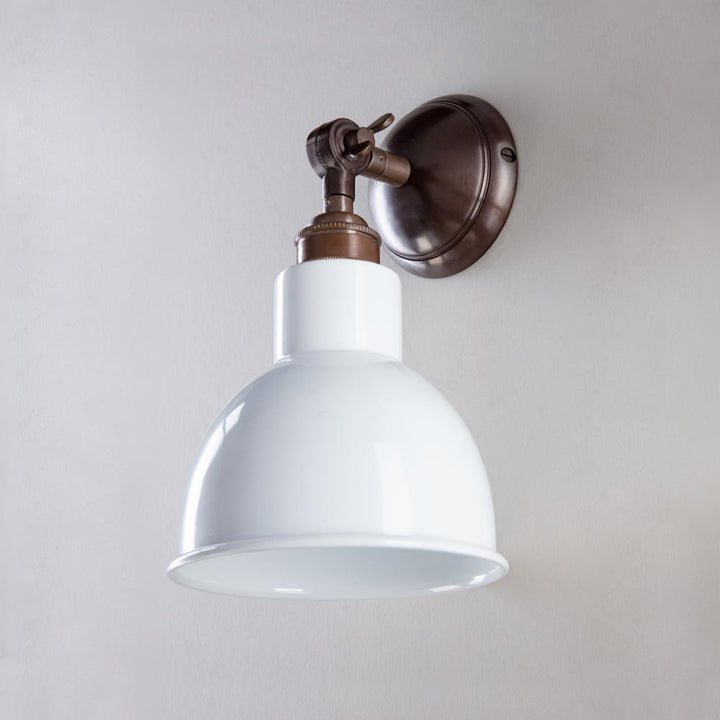 An Old School Electric Churchill Short Arm Wall Light fixture on a white wall.
