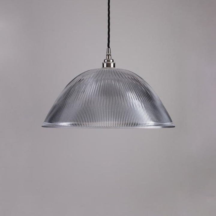 An Old School Electric Prismatic Dome Pendant Light hanging from a ceiling.
