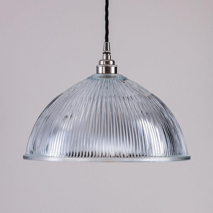 An Old School Electric Prismatic Dome Pendant Light fixture from a ceiling.