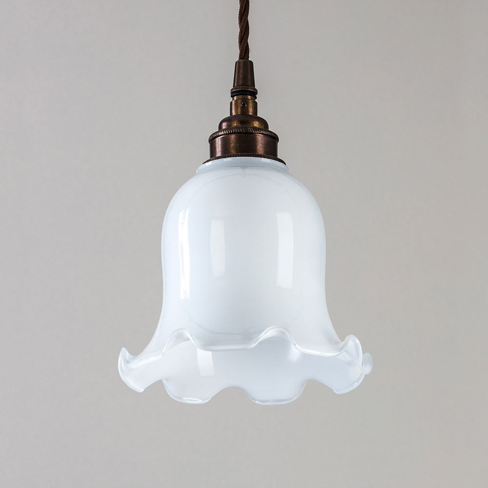 An Old School Electric Tulip Opal Glass Pendant Light with a brown shade.