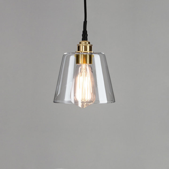 An Old School Electric Tapered Blown Glass Bathroom Pendant Light fixture with a brass base.