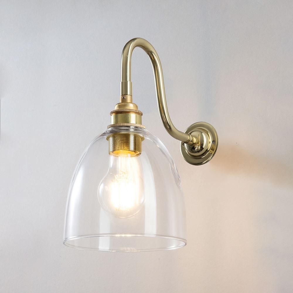 An Old School Electric Glass Swan Arm Wall Light featuring a clear glass shade.