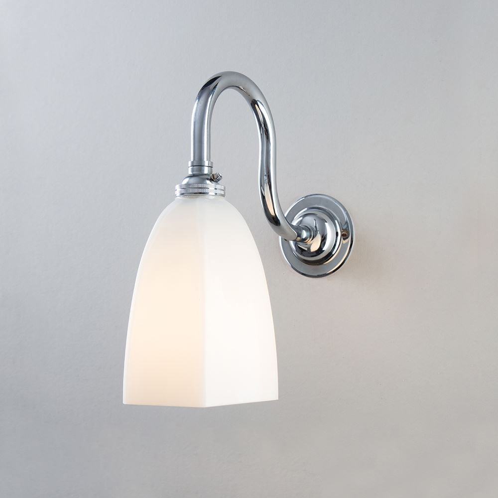 An Old School Electric Hexagon Swan Wall Light (B22) with a white glass shade is an elegant lighting fixture suitable for any interior. This electric light fitting instantly adds a touch of sophistication and ambiance to any space.