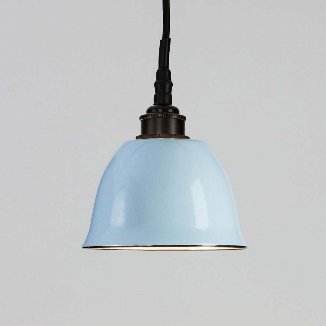 A Maison Bathroom Pendant Light from Old School Electric, with a blue shade and a black cord, perfect for adding vibrant illumination to any space.