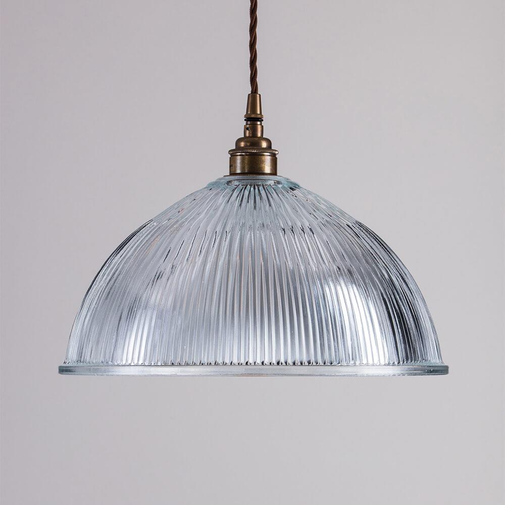 An Old School Electric Prismatic Dome Pendant Light, serving as a lighting fixture or light fitting, from a ceiling.