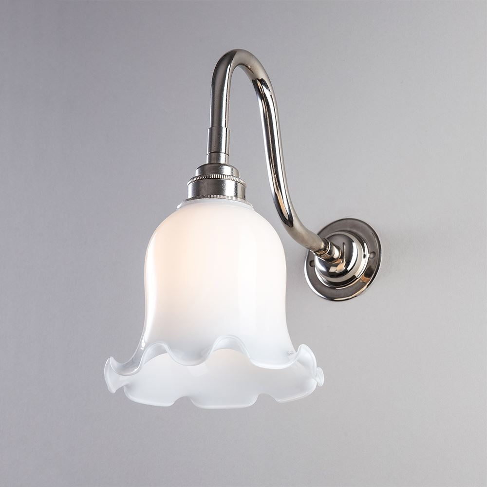 An Old School Electric Tulip Opal Glass Wall Light with a flower on it. This lighting fixture adds a charming touch to any space.
