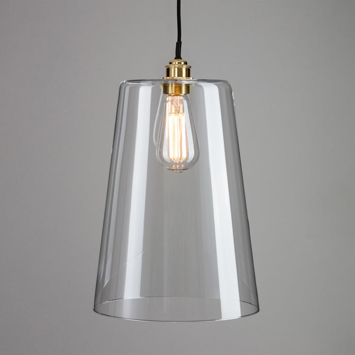 A Tapered Blown Glass Bathroom Pendant Light by Old School Electric, with a gold bulb, perfect for lighting fixtures or as a stylish light fitting.