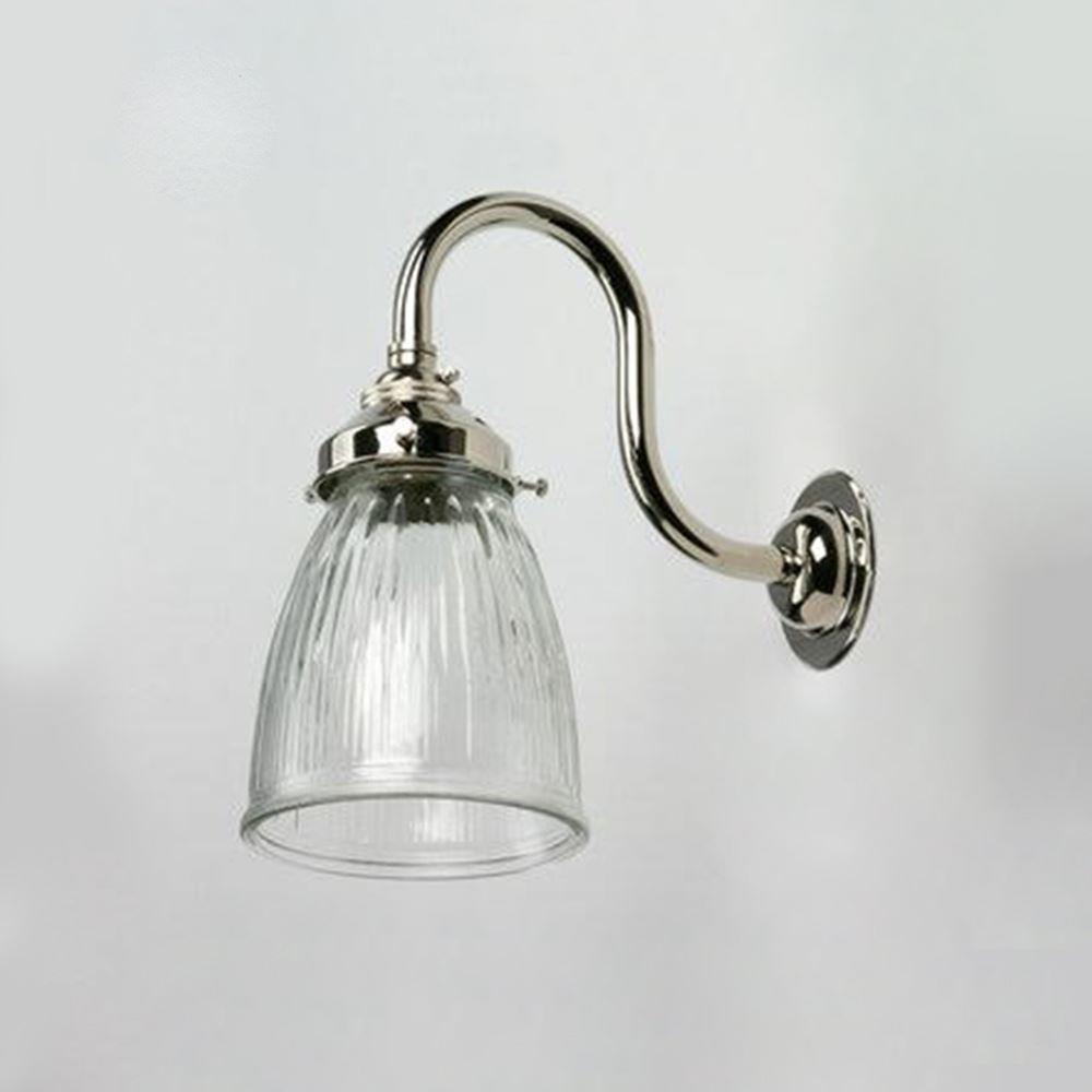 An Old School Electric Prismatic Snowdrop Bathroom Wall Light providing electric lighting on a white wall.