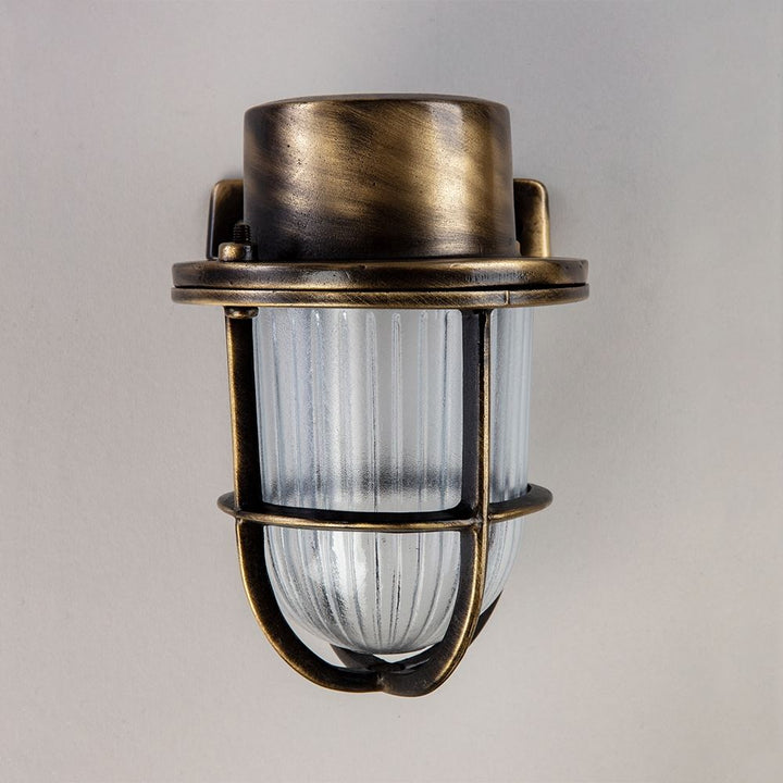 An Old School Electric Faros Mini Yacht Wall Light with a clear glass shade.