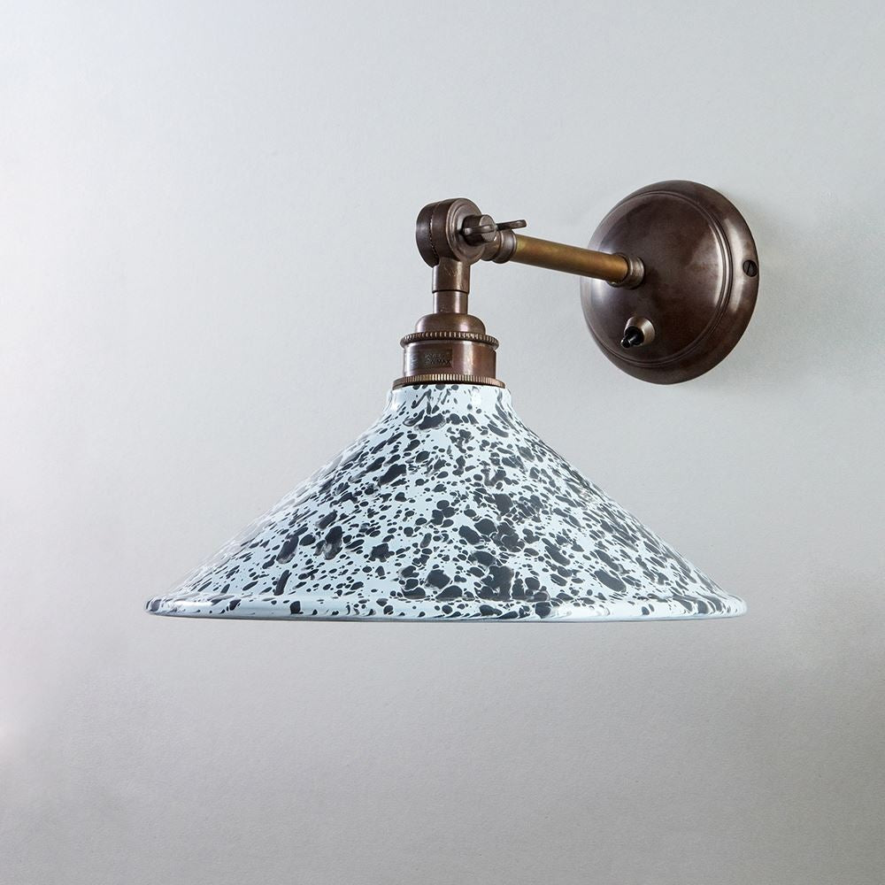 An Old School Electric Splatter Wear Shade Adjustable Arm Wall Light with a black and white speckled shade.
