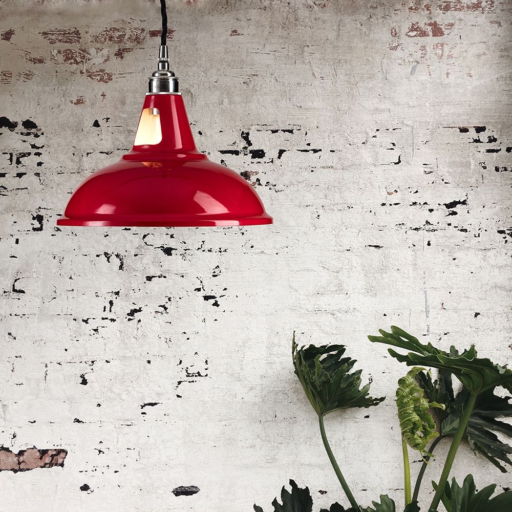 An Old School Electric Factory Pendant Light hanging from a brick wall.
