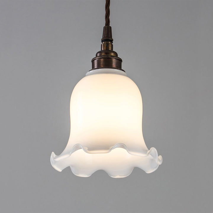 An Old School Electric Tulip Opal Glass Pendant Light, perfect for adding ambiance to any space.