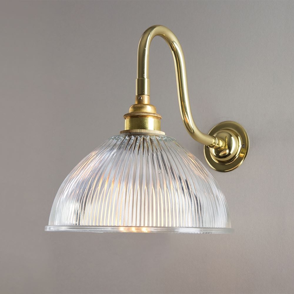 An Old School Electric Prismatic Dome Swan Arm Wall Light with a clear glass shade, perfect as a lighting fixture for any space.