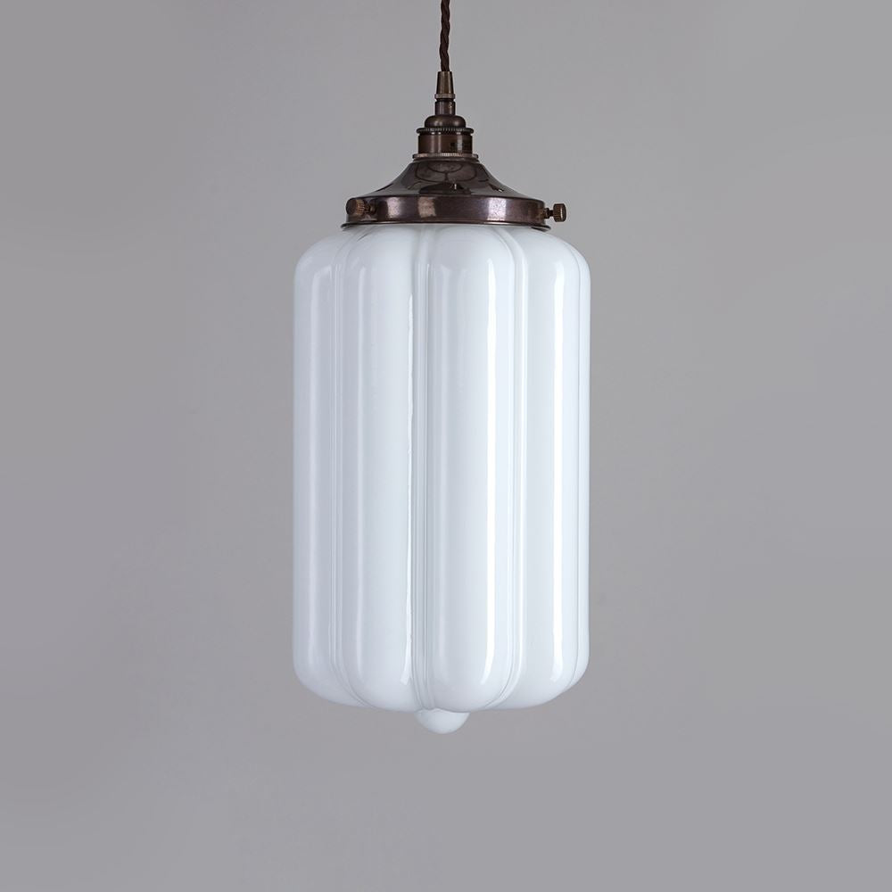 An Ellington Opal Glass Pendant Light by Old School Electric illuminating a gray background, creating a mesmerizing lighting fixture.