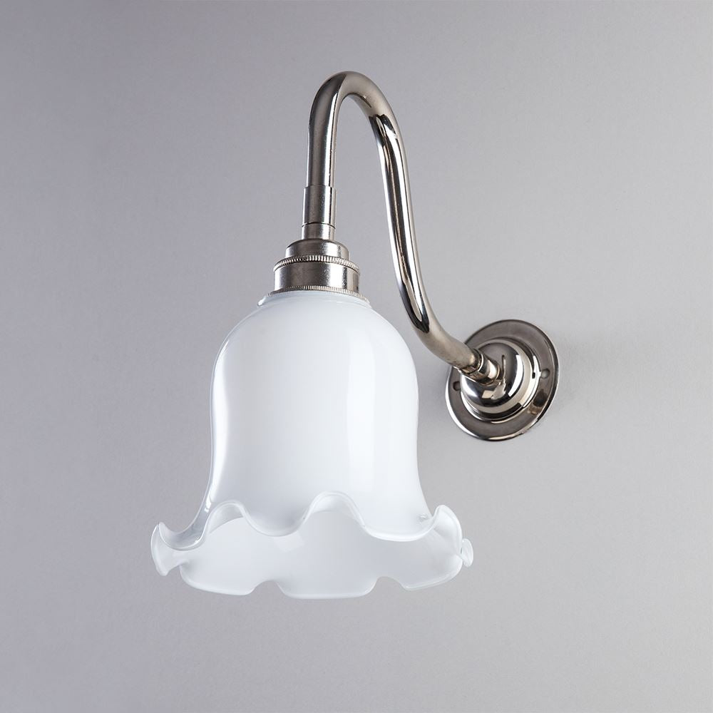 An Old School Electric Tulip Opal Glass Wall Light with a white flower-shaped light fitting.