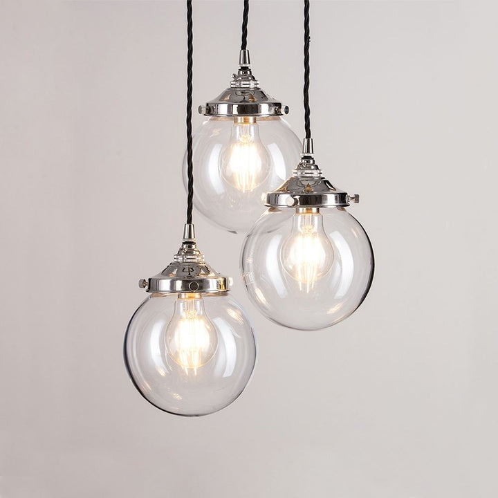 Three Old School Electric Blown Clear Glass Cluster Pendant Lights hanging from a chain, creating a stunning light fixture.