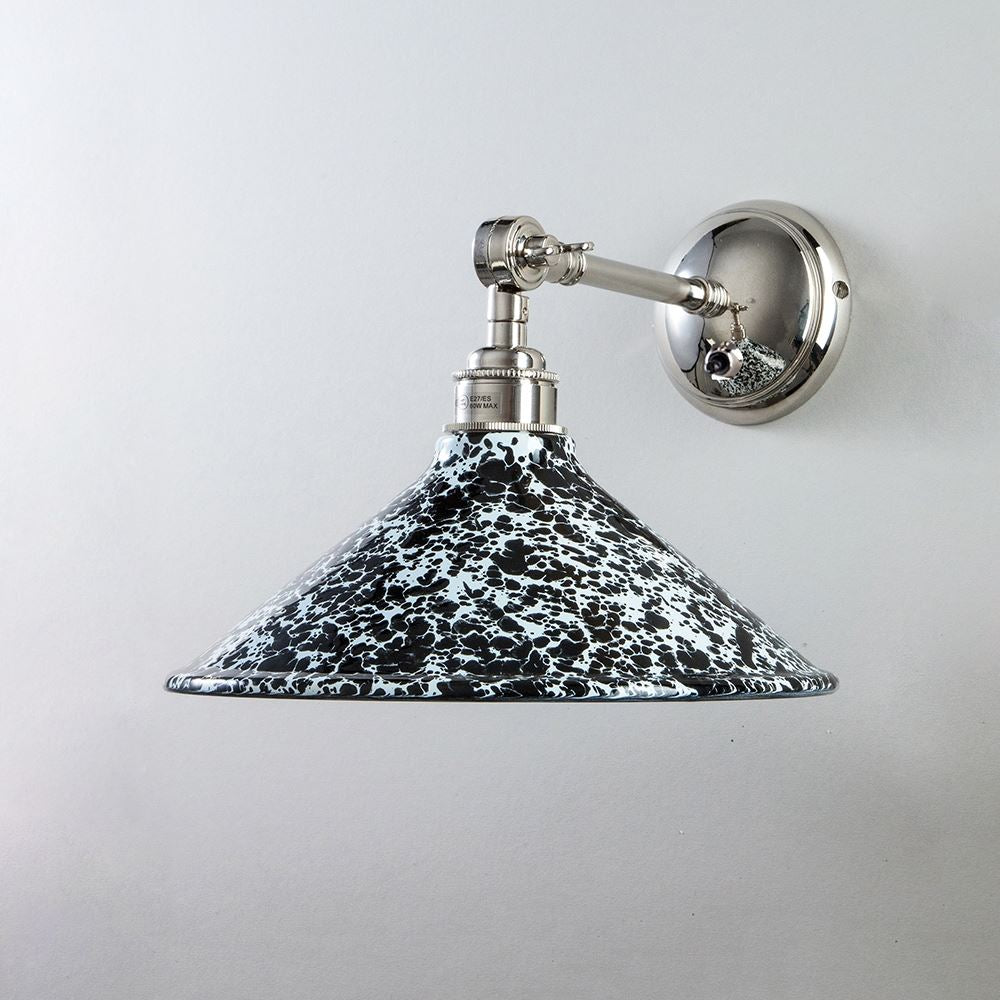 A black and silver Splatter Wear Shade Adjustable Arm Wall Light by Old School Electric with a white shade.